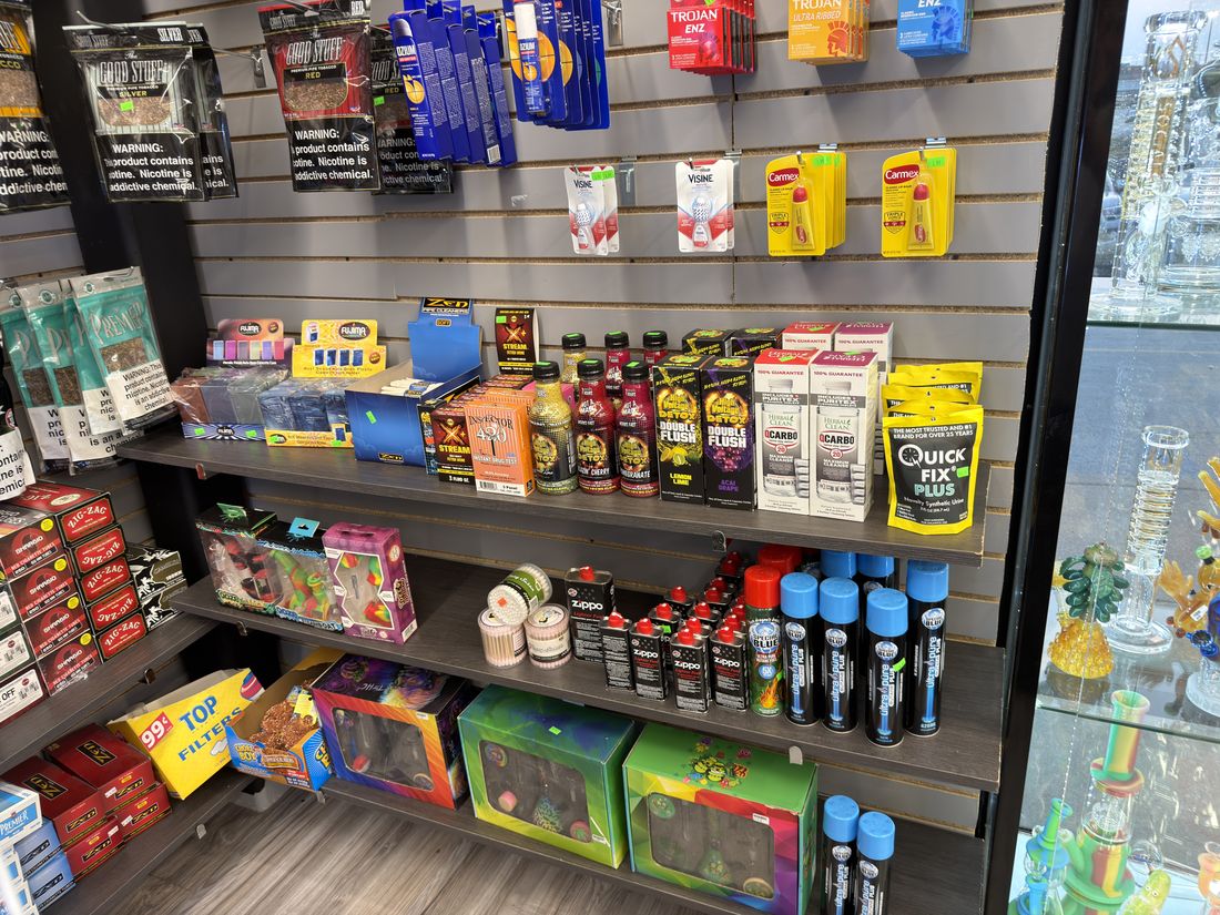 Shelf of lighters, torches, cleaners and smoking accessories