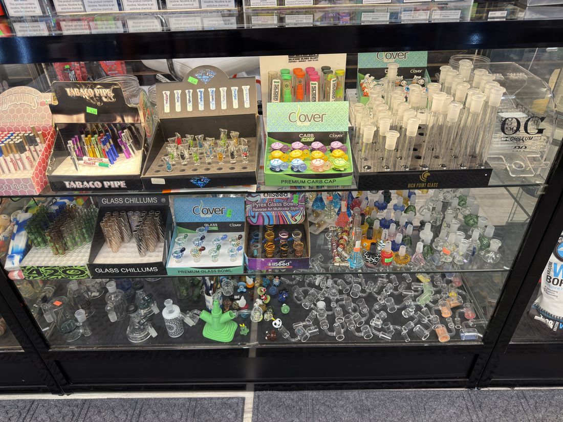Glass chillums, carb caps and tobacco pipes in the counter case