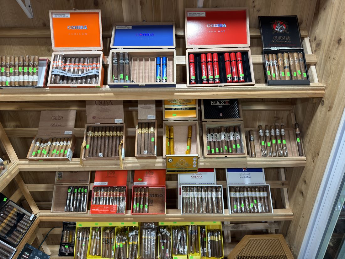 Cigarillos and machine-made cigars on the wooden display rack