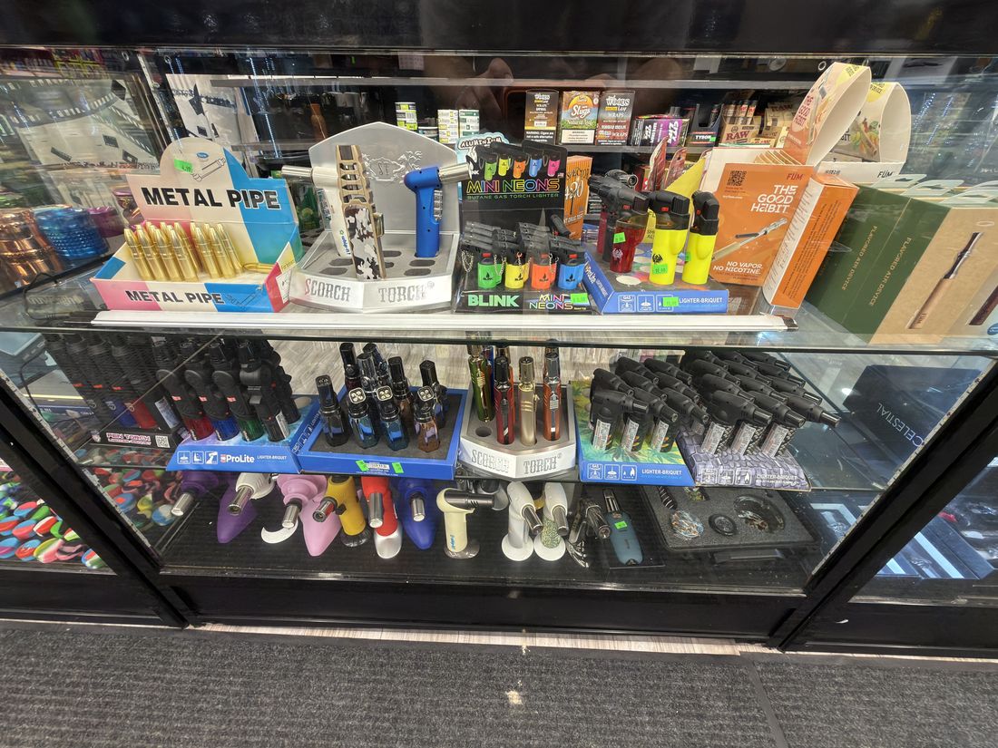 Metal pipes, lighters and filter tips in the counter case