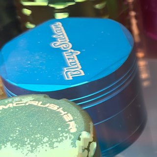 Blazy Susan Cyan 4-Piece Grinder on the shelf at Glen Smoke Shop