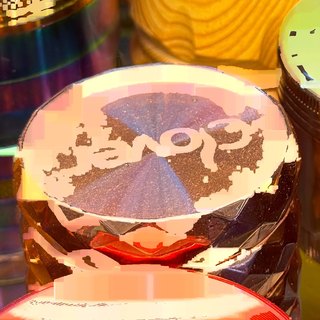 Clover Amber 3-Piece Acrylic Grinder on the shelf at Glen Smoke Shop