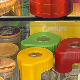 Glass Jar with Green Silicone Cap on the shelf at Glen Smoke Shop