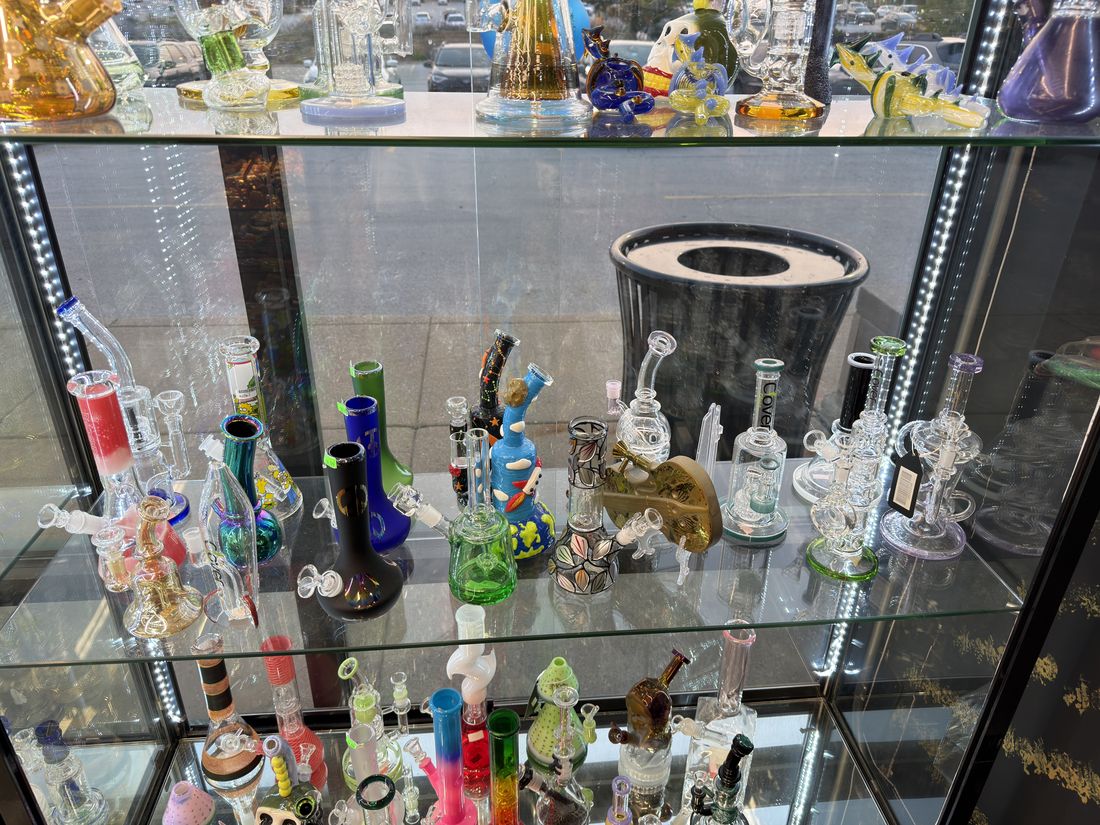 Glass cases seen from the counter, water pipes on every shelf