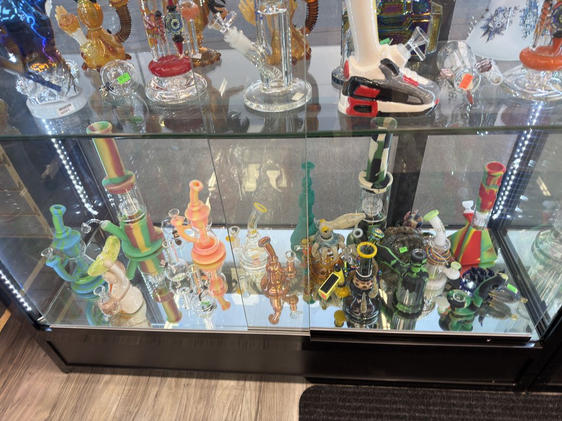Coloured dab rigs and small bubblers on a lit shelf