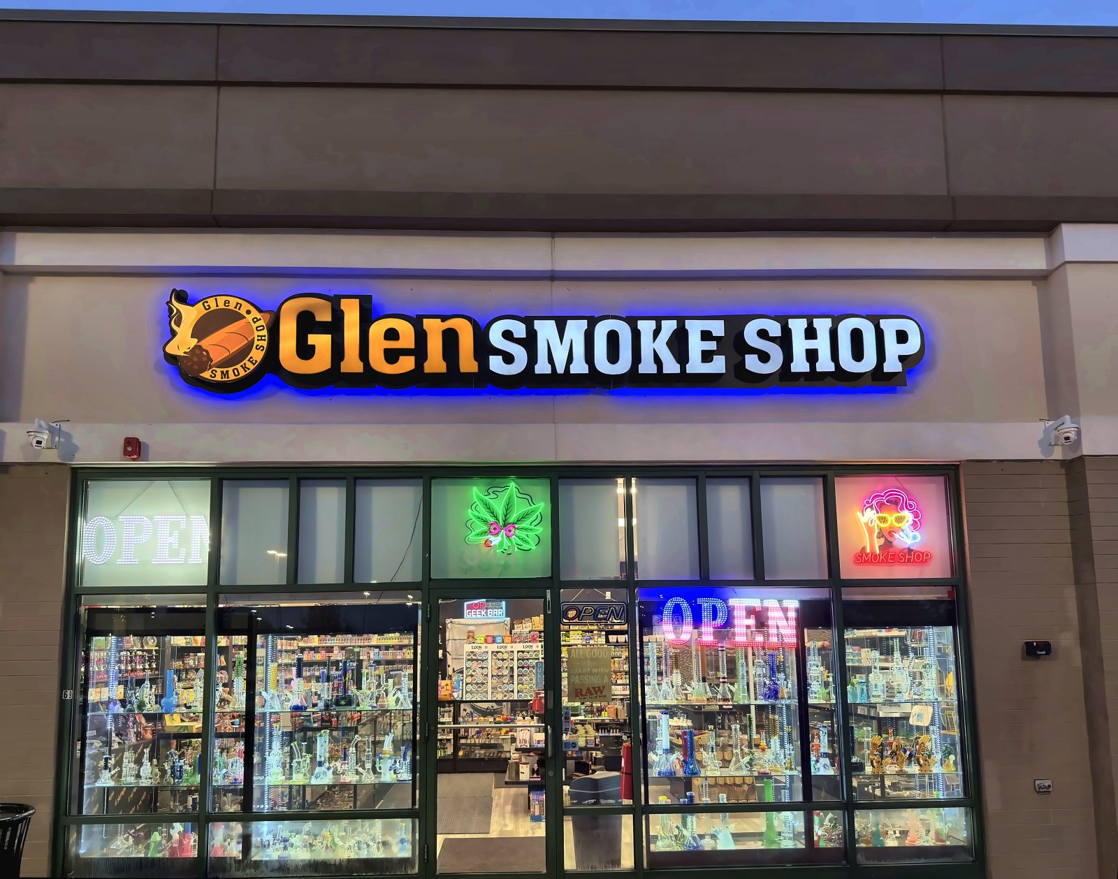 Glen Smoke Shop storefront lit up at night