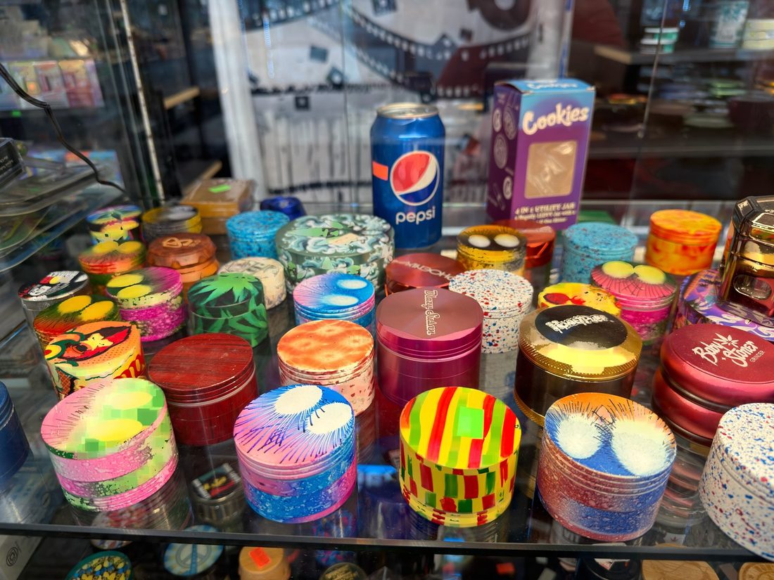 Hand-finished and patterned grinder lids in the counter display case