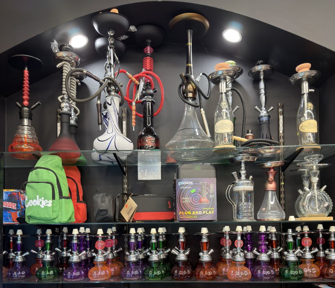 Hookah stems, bowls and hoses on lit shelving at Glen Smoke Shop