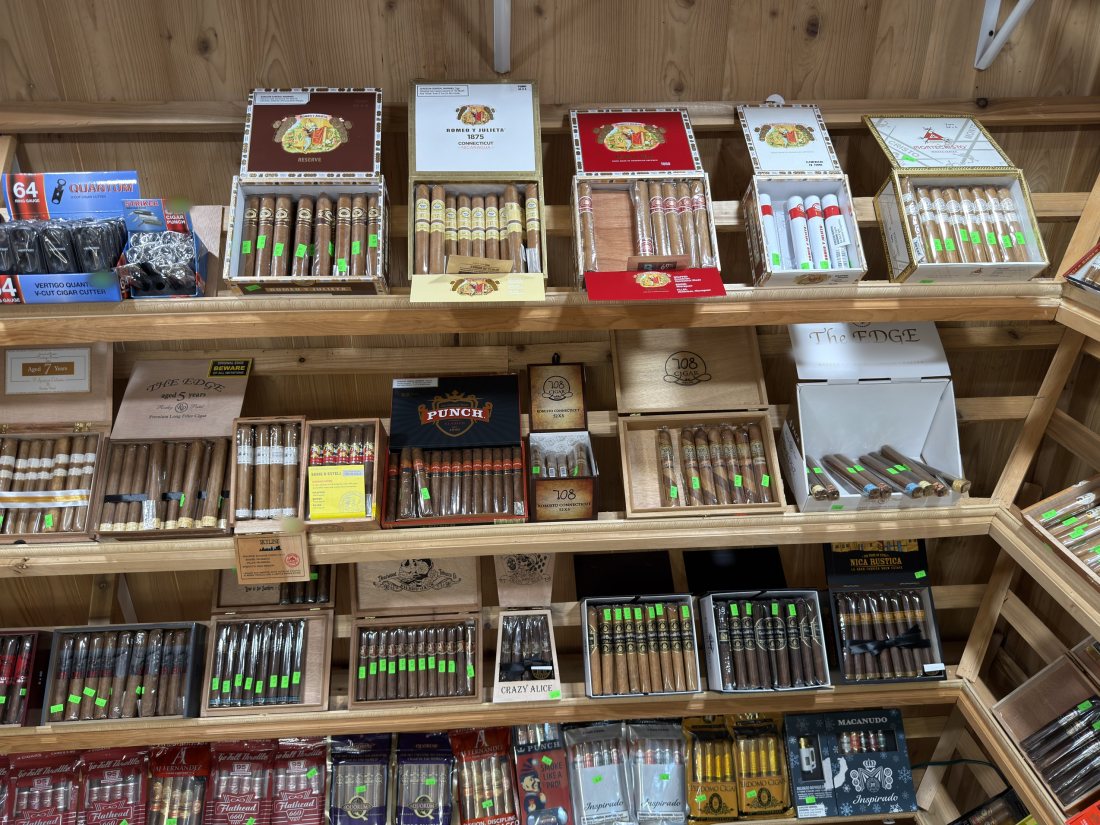Open cigar boxes in the walk-in humidor at Glen Smoke Shop
