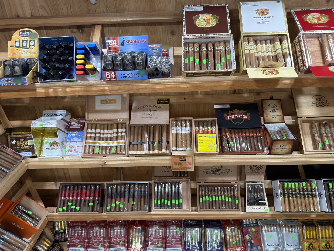 Premium cigar singles and boxes on cedar shelving