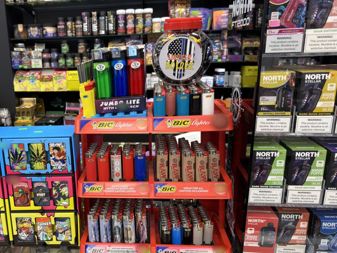 BIC and Clipper lighter displays beside jumbo disposables