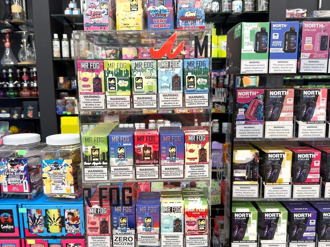 A Mr Fog counter display of disposable vapes beside the register