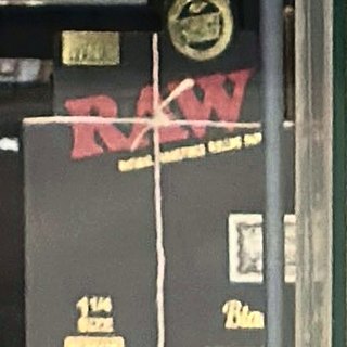 RAW Black 1 1/4 Rolling Papers on the shelf at Glen Smoke Shop