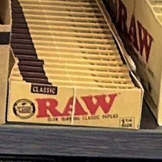 RAW Classic 1 1/4 Rolling Papers on the shelf at Glen Smoke Shop