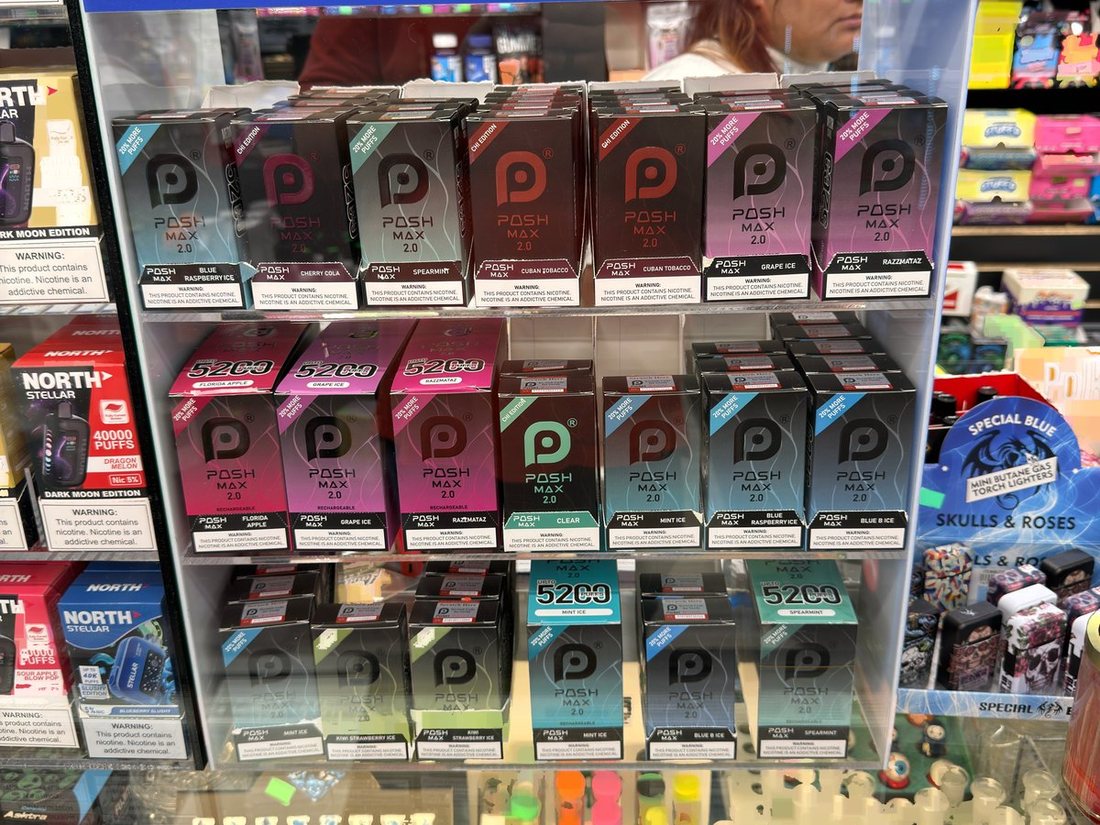 A Posh Max counter display of disposable vapes at the front counter
