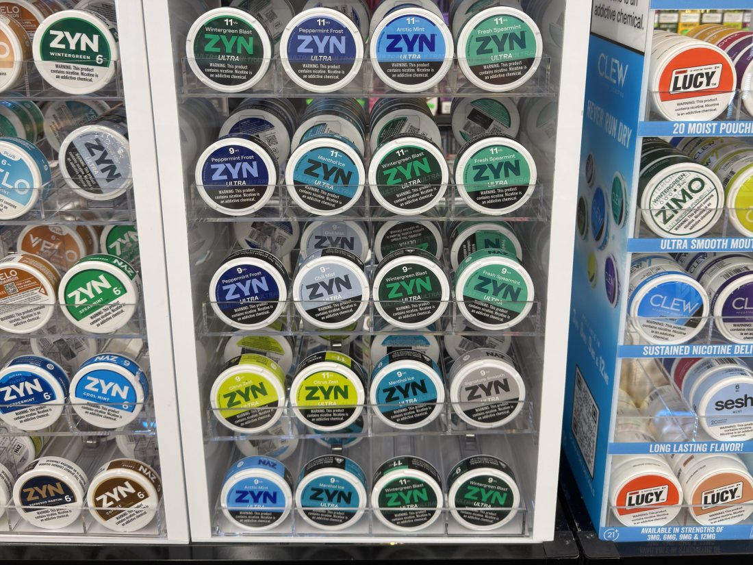 A LOON NYXX and ZYN nicotine pouch rack filled with tins