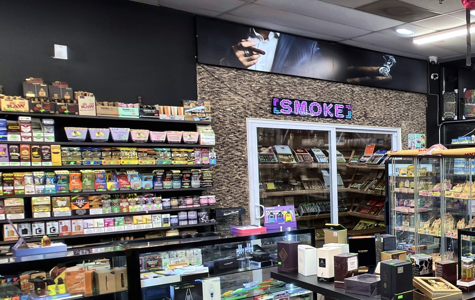Wide view of the sales floor, shelves and cases on every wall