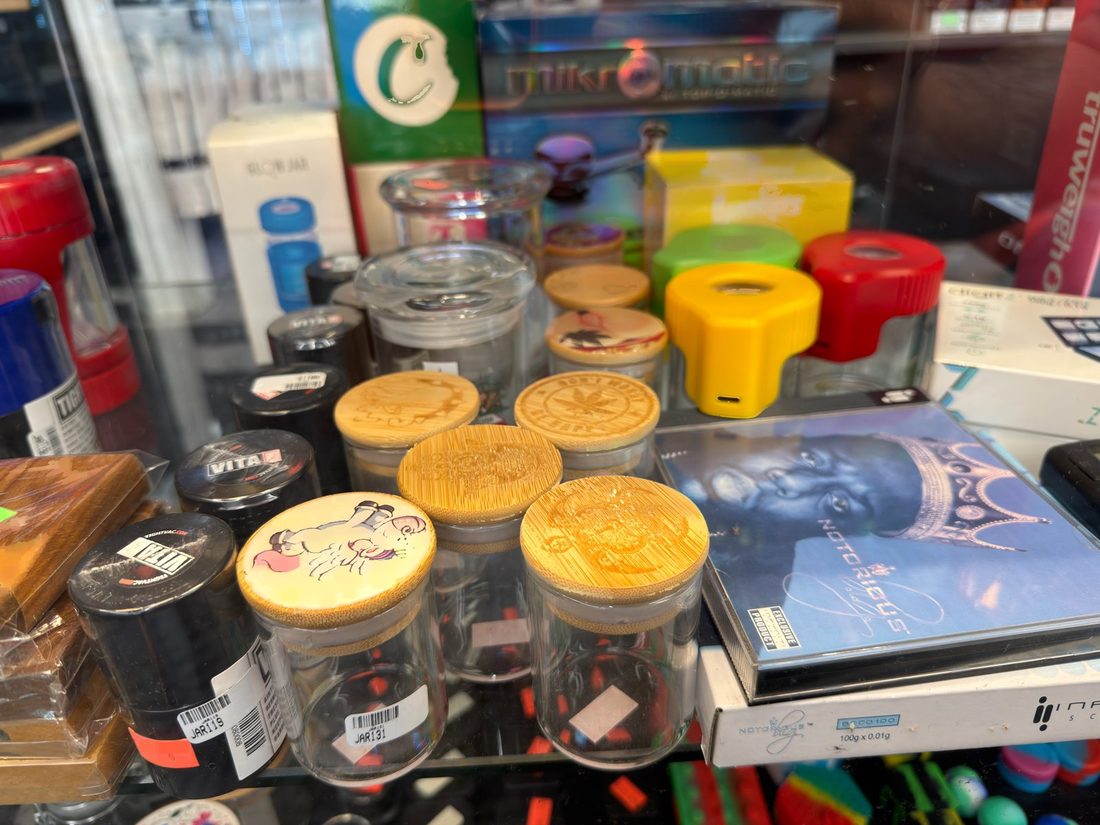 Glass storage jars with wood and silicone lids beside boxed digital scales