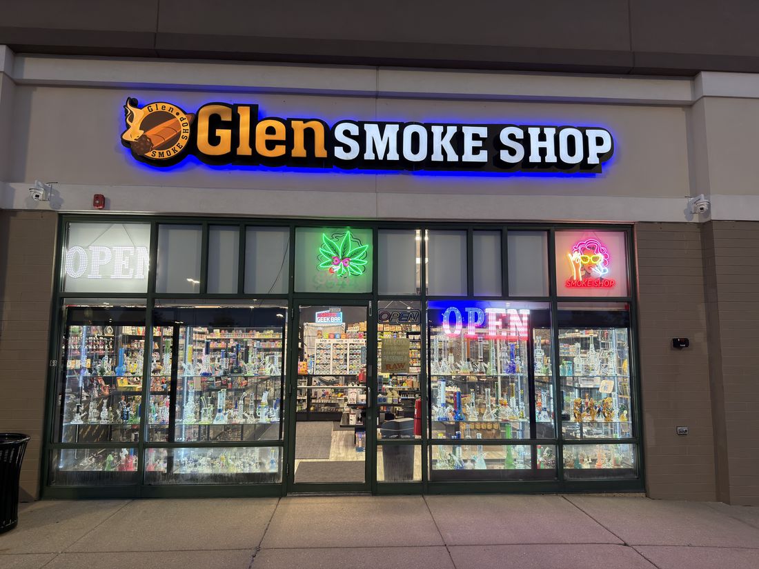 Glen Smoke Shop storefront lit at night on Roosevelt Road