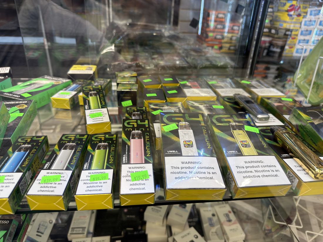 Vape hardware and disposables laid out in the counter case