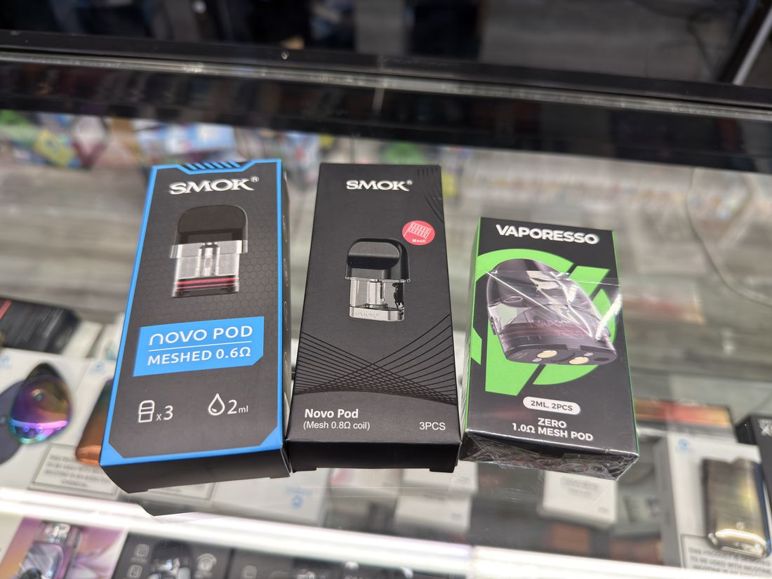 SMOK and Vaporesso replacement pods and coils in the counter case