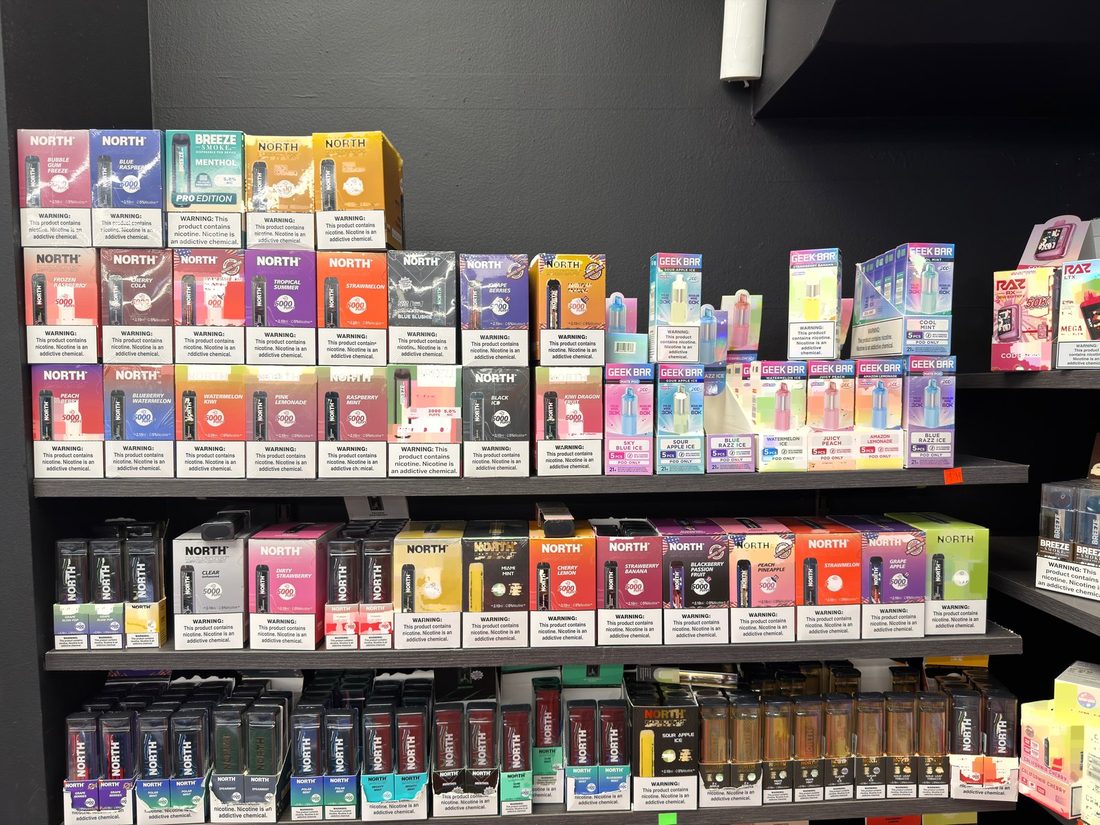 North and Geek Bar disposables filling a bay of the vape wall