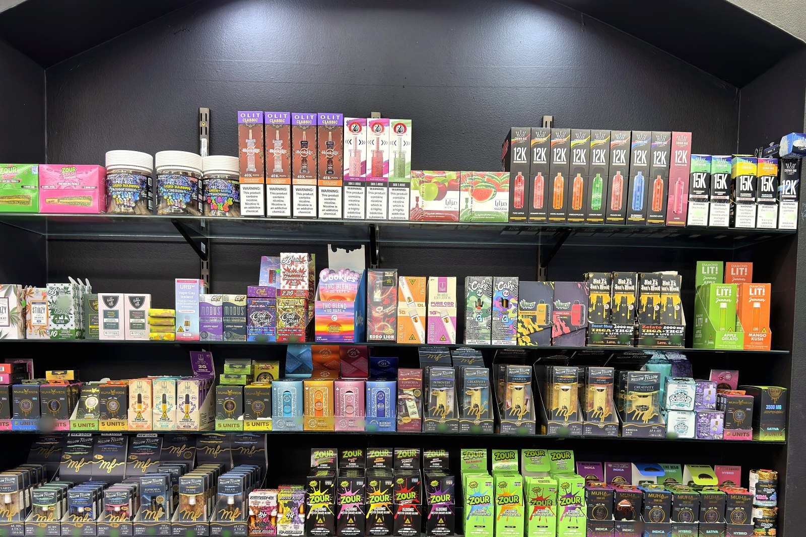 A stocked shelf bay of vapes, wraps and hemp-derived products